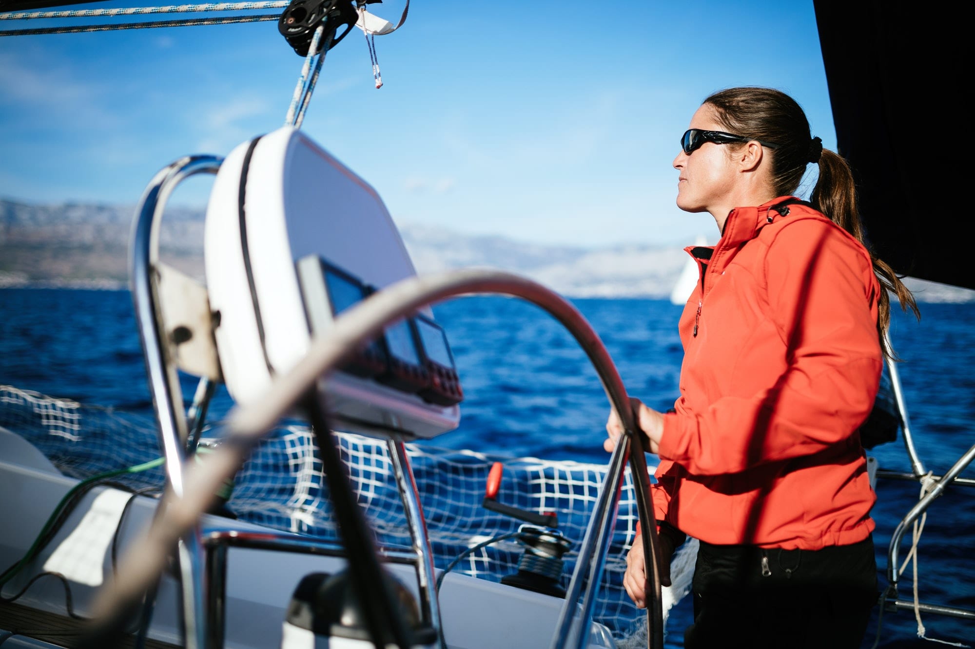 Attractive strong woman sailing with her boat Dubai Offshore Sailing Club