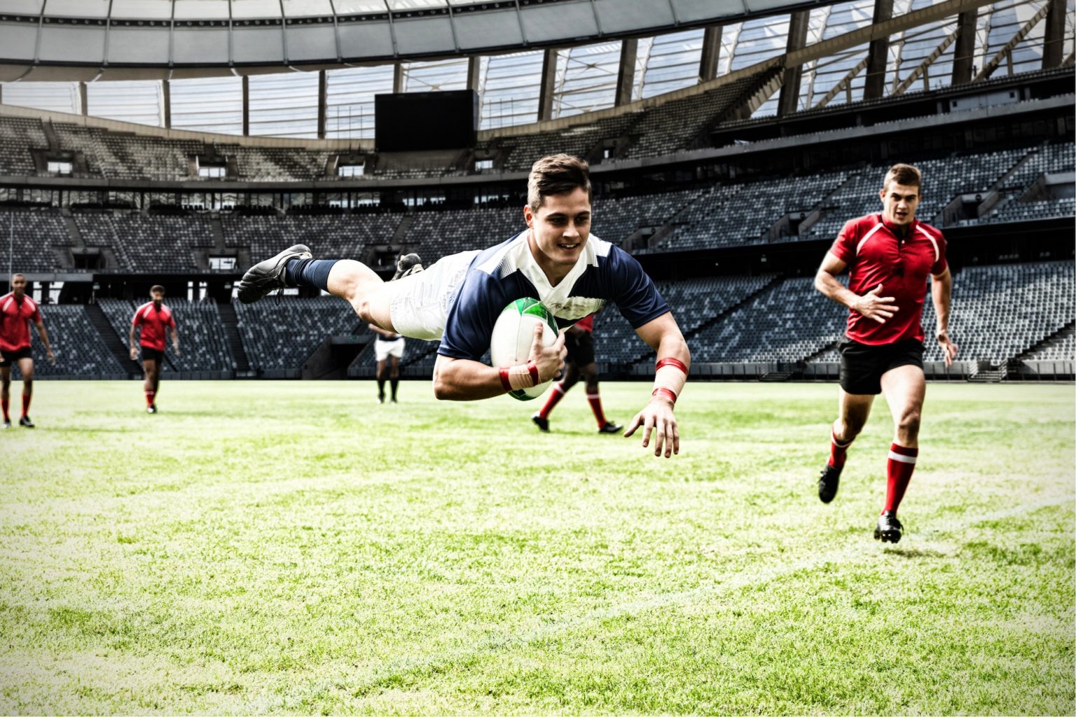 Digital composite image of rugby player jumping with the ball in sports stadium