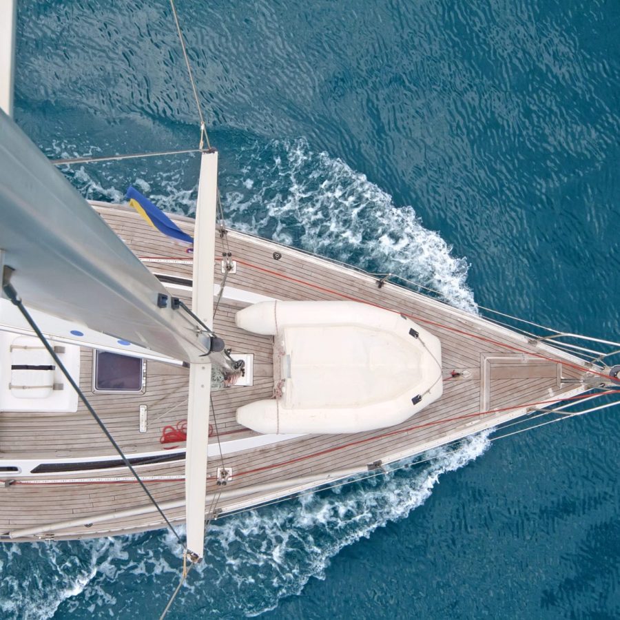 Top view of sailing boat with water splash